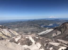 The summit of Mount Saint Helens. Spirit lake and Mount Rainier in the distance.